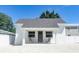 Newly renovated white cottage features a gray roof and welcoming front porch at 2871 Bahia Vista St, Sarasota, FL 34239