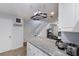 Kitchen with granite countertops, white cabinets, and a view into living area at 3304 Ramblewood Pl, Sarasota, FL 34237