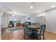 Living room with hardwood floors, teal table and chairs, and a view of stairs at 3304 Ramblewood Pl, Sarasota, FL 34237