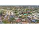 Aerial view of a residential neighborhood with houses, trees, and a small lake at 3507 68Th W St, Bradenton, FL 34209