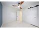 Bedroom with ceiling fan, white walls, and terrazzo flooring at 3817 Buckeye Cir, Sarasota, FL 34232