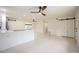 Modern kitchen with white cabinets and island, open to living area at 3817 Buckeye Cir, Sarasota, FL 34232