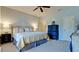 Spacious bedroom with a large bed, blue dresser, and ceiling fan at 4046 Overture Cir # 4046, Bradenton, FL 34209