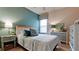 Cozy bedroom with white bed and dresser, teal walls, and window at 4046 Overture Cir # 4046, Bradenton, FL 34209