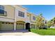 Tan townhouses with attached garages and manicured hedges at 4046 Overture Cir # 4046, Bradenton, FL 34209