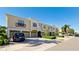 Tan three-story townhouses with attached garages, and lush landscaping at 4046 Overture Cir # 4046, Bradenton, FL 34209