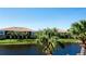 Tranquil lake view with lush landscaping and palm trees at 4046 Overture Cir # 4046, Bradenton, FL 34209