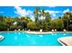 Resort-style pool with lounge chairs and lush landscaping at 4046 Overture Cir # 4046, Bradenton, FL 34209