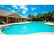 Community pool with lounge chairs and adjacent building at 4046 Overture Cir # 4046, Bradenton, FL 34209