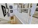 Elegant staircase with a white railing and framed Gathering photos at 4046 Overture Cir # 4046, Bradenton, FL 34209