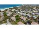 An aerial view shows multi-Gathering homes with parking, lush landscaping, and easy access to the beach at 4255 Gulf Dr # 116, Holmes Beach, FL 34217