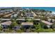 Aerial view of multi-Gathering homes surrounded by lush landscaping near a beach, perfect for vacation rentals at 4255 Gulf Dr # 116, Holmes Beach, FL 34217