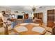 Bright dining area with wood table and chairs, hardwood floors, and built-in shelving at 4255 Gulf Dr # 116, Holmes Beach, FL 34217