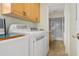 Well-equipped laundry room with washer, dryer, and cabinet storage at 4255 Gulf Dr # 116, Holmes Beach, FL 34217