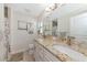 Modern bathroom featuring double sinks, granite countertop, and stylish light fixtures at 4344 Eldron Ave, North Port, FL 34286