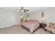 Main bedroom featuring a king-size bed, ensuite bathroom, and ceiling fan at 4344 Eldron Ave, North Port, FL 34286