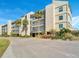 Condo building exterior, featuring landscaping and parking at 4540 Gulf Of Mexico Dr # 204, Longboat Key, FL 34228