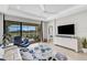 Living room with pool view, white leather sofa, and a large TV at 4735 Motta Ct, Bradenton, FL 34211