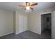 Bright bedroom featuring a ceiling fan, carpet, and door to hallway at 4850 51St W St # 8104, Bradenton, FL 34210