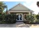 Community clubhouse with double doors and landscaping at 4850 51St W St # 8104, Bradenton, FL 34210
