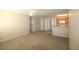 Spacious living room with carpet and kitchen access at 4850 51St W St # 8104, Bradenton, FL 34210