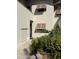 Condo building exterior featuring landscaped grounds and individual unit entrance at 5171 Willow Links # 23, Sarasota, FL 34235