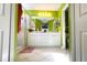 Bright bathroom with double sinks, white cabinets and green walls at 5613 Key Largo Ct, Bradenton, FL 34203