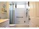 Bathroom with white fixtures, blue shower curtain, and grab bars at 5613 Key Largo Ct, Bradenton, FL 34203