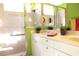 Dual vanity bathroom featuring white cabinetry, a walk-in shower, and green accents at 5613 Key Largo Ct, Bradenton, FL 34203