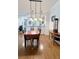 Dining area with hardwood floors, pendant lighting, and a view into the adjacent kitchen at 5613 Key Largo Ct, Bradenton, FL 34203