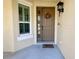 Front porch with brown door, window with shutters, and a welcome mat at 5613 Key Largo Ct, Bradenton, FL 34203