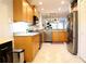 Spacious kitchen with light wood cabinets, granite countertops, and stainless steel appliances at 5613 Key Largo Ct, Bradenton, FL 34203