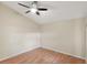 Spacious bedroom with wood-look floors and ceiling fan at 5638 Monte Rosso Rd, Sarasota, FL 34243