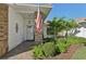 Welcoming front entrance with brick columns, lush landscaping, and a white door at 5808 Garden Lakes Majestic, Bradenton, FL 34203