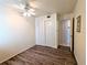 Bedroom with wood-look floors and double door closet at 5889 Garden Ln # H4, Bradenton, FL 34207