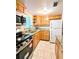 Full view of kitchen with granite countertops, cabinets, and appliances at 5889 Garden Ln # H4, Bradenton, FL 34207