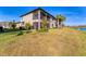 Two-story condo with water view, screened balcony, and landscaped yard at 6035 Worsham Ln # 104, Lakewood Ranch, FL 34211