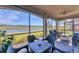 Screened lanai overlooking a pond with seating and a fire pit at 6035 Worsham Ln # 104, Lakewood Ranch, FL 34211