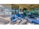 Relaxing screened lanai with outdoor furniture and a TV at 6035 Worsham Ln # 104, Lakewood Ranch, FL 34211