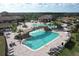 Large resort-style pool with multiple areas and a rock waterfall feature at 6035 Worsham Ln # 104, Lakewood Ranch, FL 34211