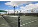 Well-lit tennis courts with green surface at 6035 Worsham Ln # 104, Lakewood Ranch, FL 34211