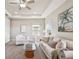 Living area featuring white armchairs, a sofa, built-in shelving, and plush carpeting at 6227 Anise Dr, Sarasota, FL 34238