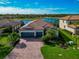 Aerial view of a beautiful house and a desirable community with a lake at 6720 Wild Lake Ter, Bradenton, FL 34212