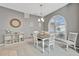 Bright dining room features a table with chairs and an arched window at 6880 Corral Cir, Sarasota, FL 34243