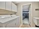 Convenient laundry room with washer, dryer, and garage access at 6880 Corral Cir, Sarasota, FL 34243