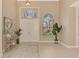 Bright and airy foyer with hardwood floors and neutral decor at 72 Arbor Oaks Dr, Sarasota, FL 34232