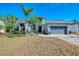 Beautiful two-story home with a gray exterior, landscaping, and a two-car garage at 72 Arbor Oaks Dr, Sarasota, FL 34232