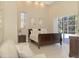 Spacious main bedroom with king-size bed and access to the pool area at 72 Arbor Oaks Dr, Sarasota, FL 34232