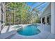 Inviting kidney-shaped pool with spa and screened enclosure at 72 Arbor Oaks Dr, Sarasota, FL 34232