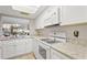 Updated kitchen boasting granite countertops and white cabinetry at 759 N Jefferson Ave # 759, Sarasota, FL 34237